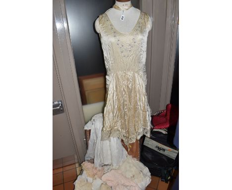 ONE SUITCASE AND LOOSE LATE 19TH AND EARLY 20TH CENTURY LADIES' AND CHILDREN'S CLOTHING, comprising a champagne coloured 1920