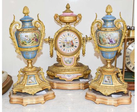 A French Gilt Metal Pink Porcelain Mounted Striking Mantel Clock, circa 1890, on a gilt wooden base, 34cm high, together with