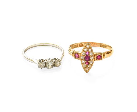 A Ruby and Diamond Ring, the navette cluster formed of cushion cut rubies and rose cut diamonds, in yellow claw and millegrai
