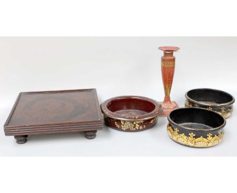A Pair of Regency Lacquered Papier Mache Bottle Coasters, together with a similar example, a toleware candlestick, and a reed
