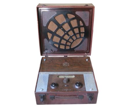 A portable radio receiver, McMichael Super Range Portable Four, No. 52180, in leather case with bakelite speaker fret in lid 