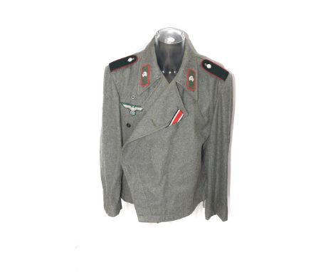 A German SS/Army-style jacket and trousers, with epaulettes, skull collar badges, eagle and swastika cloth badge please form 