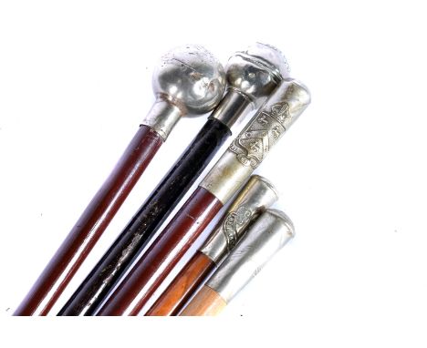 A group of five Regimental Swagger Sticks, all with white-metal top, comprising Royal Army Service Corps, The Manchester Regi