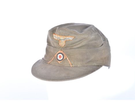 A German Army style cap, with eagle and swastika badge with lower insignia please form own opinion on authenticity before bid