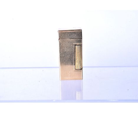 A 14k gold Dunhill Rollalite pocket lighter,  with vertical line decoration, with roller to side, marked 'outer jacket 14k go