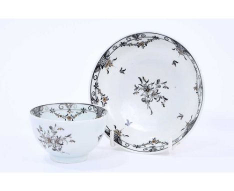 Lowestoft tea bowl and saucer, pencilled in black with flower sprays and formal borders of diaper and flower garlands, picked