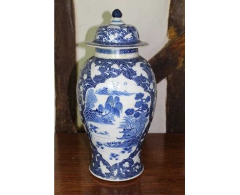 18th century Chinese porcelain blue and white vase and cover, of baluster form, with landscape reserves on relief moulded, si