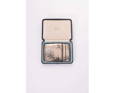 20th Century Japanese silver cigarette case of curved rectangular form with niello work decoration of bamboo trees, stamped s