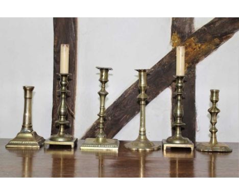 Group of 18th/19th century brass candlesticks, to include Queen Anne stick on shaped square base, 18cm high, 6 in totalProven