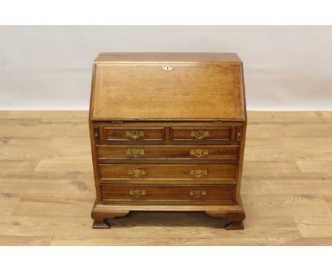 Miniature mahogany bureau, in the George II style, with sloping fall enclosing well fitted interior and two short over three 