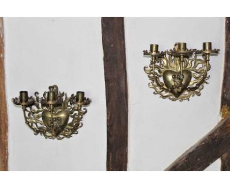 Pair of 19th century gothic brass three branch wall lights, each with flaming heart bracket insuing three candle arms, 22cm h