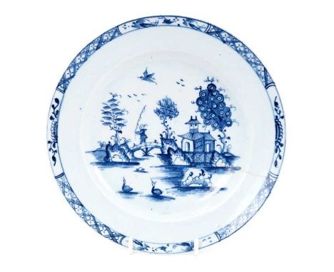 Lowestoft plate, painted in blue with a chinaman crossing a bridge with a fishing rod, a bird in flight above, diaper and hal