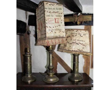 Pair of antique brass lamp bases, with tooled arabesque or ornament, bases 36cm high, together with a similar brass lamp, two