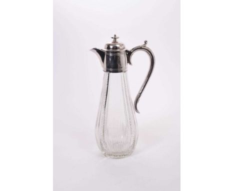 Victorian cut glass claret jug of baluster form, silver plated mount with reeded decoration and hinged cover, with scroll han