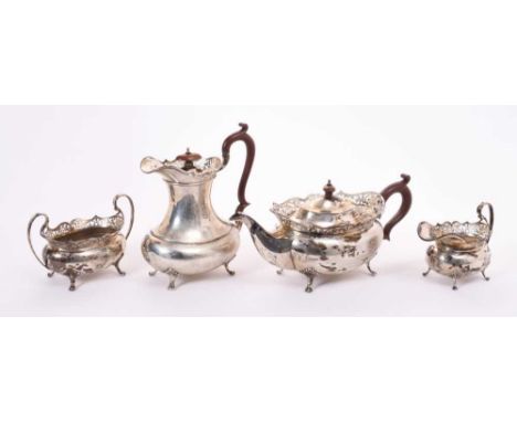 George V four piece silver teaset comprising, teapot of compressed baluster form with pierced flared border, scroll handle an