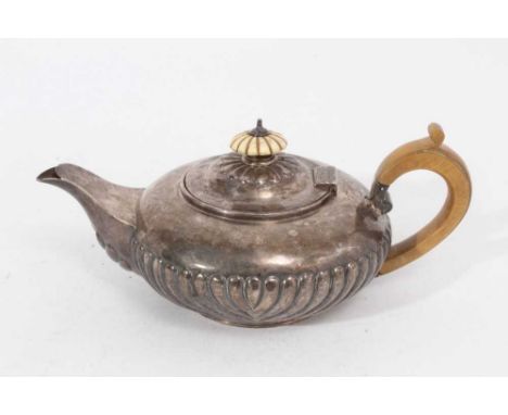 George IV silver teapot of squat form with fluted decoration, domed hinged cover with ivory finial and fruitwood handle, on c