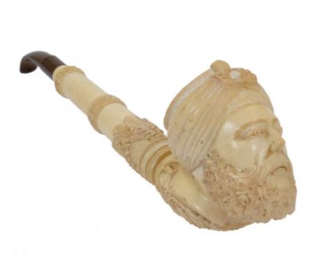 Large 19th century carved meerschaum pipe, the terminal carved as a turk's head, the stem with foliate bands, total length 32