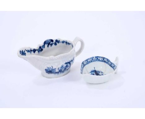 Two Lowestoft butter boats, the first of gadrooned form, painted in blue with the Two Porter pattern, a floral border on the 