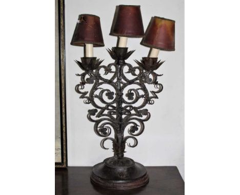 Arts and Crafts wrought iron lamp, with three lights and scrolling stem issuing from circular base, 60cm highProvenance: The 
