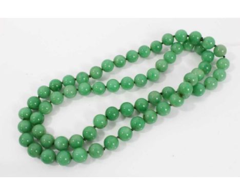 Chinese green jade/hardstone necklace with a string of 12mm diameter beads, approximately 84cm length.Condition report: Very 