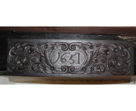 Mid 17th century oak relief panel dated 1651 within scrolling cartouche, 17cm x 58cmProvenance: The Robert Barley Collection