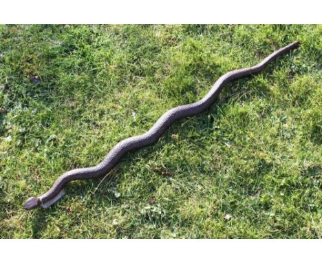 Late 19th century Indian finely carved wooden staff in the form of a snake with inset glass eyes, 95cm longProvenance: The Ro