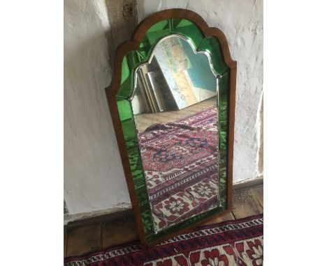 Art Deco walnut and coloured glass wall mirror, stepped arched form with green peripheral plates, 81 x 40.5cmProvenance: The 