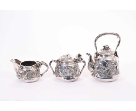 Early 20th century Japanese silver three piece tea set, comprising teapot of bell form with embossed and applied decoration i