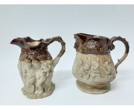 Two large 19th century relief-moulded salt glazed pottery jugs, the first decorated with Bacchanalian scenes, 22cm high, the 