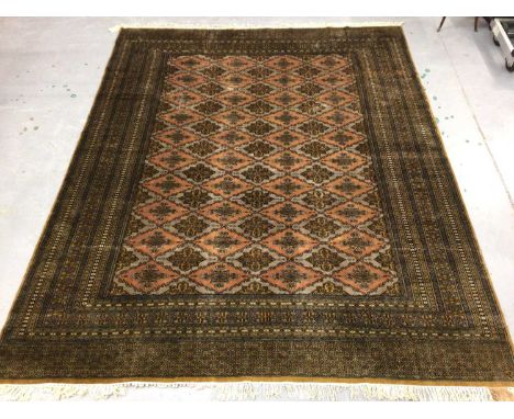 Large Pakistani carpet, with repeat flower head design to the gold field, in multiple geometric borders and tassel ends, appr