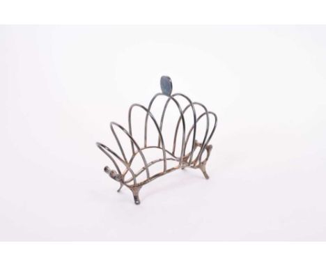 Edwardian wire frame toast rack of arched form with scroll ends, raised on four bracket feet, (London 1905), maker William Co