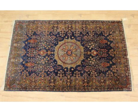 Part silk Kashan rug, with central medallion and floral vases on midnight blue ground within main meander border, 210 x 126cm