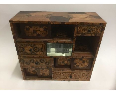 Large Japanese parquetry inlaid cabinet, with central mirrored open compartment and an arrangement of drawers and sliding doo