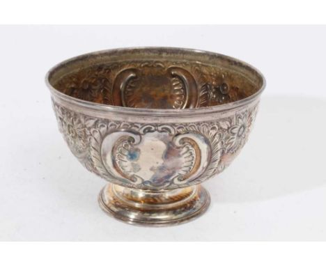 Victorian silver rose bowl of conventional form with embossed floral, foliate and scroll decoration, raised on a circular ped