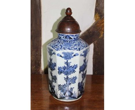 17th/18th century Japanese baluster vase, with associated carved hardwood cover, the hexagonal vase decorated in blue and whi