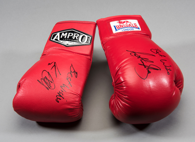 Boxing gloves signed by Anthony Joshua and Kevin Mitchell, a red ...