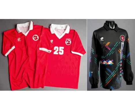 Two red Switzerland international jerseys circa 1994,
the first a short-sleeved No.25 World Cup '94 issue, but with no player