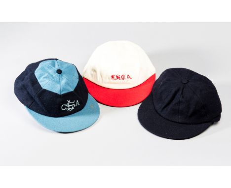 A trio of cricket caps that belonged to the England 1966 World Cup winning football captain Bobby Moore,
a blue Tom Hood Scho