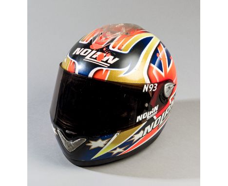 2003 Casey Stoner 125cc GP race worn and crashed helmet,
the Nolan N93 ventilated race helmet with darkened visor and full li