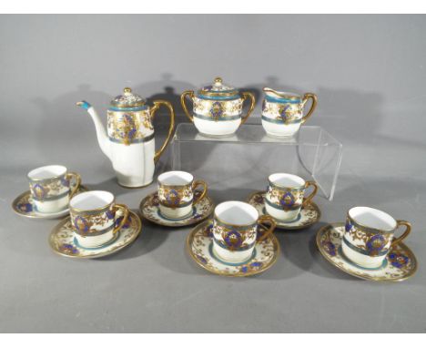 Noritake - A Noritake coffee set decorated in blue and gilt, comprising coffee pot, six coffee cans and saucers, creamer and 