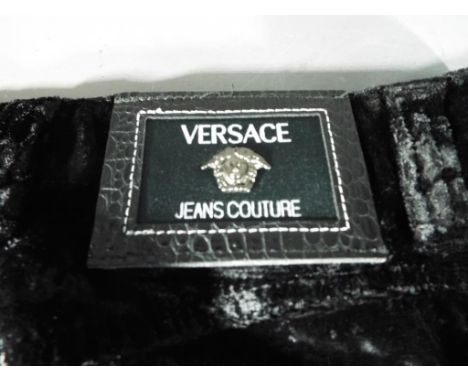 Designer clothing - a pair of black velvet trousers marked Versace Jeans Couture with all buttons and press studs marked with