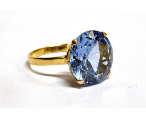 A 9CT GOLD SYNTHETIC BLUE SPINEL SINGLE STONE DRESS RING  the large light blue synthetic spinel approx. 15mm diameter, four c