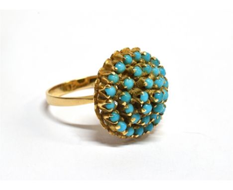 A TURQUOISE FOUR TIER ROUND CLUSTER YELLOW GOLD RING  the cluster comprising small round cabochon cut turquoise to a plain po