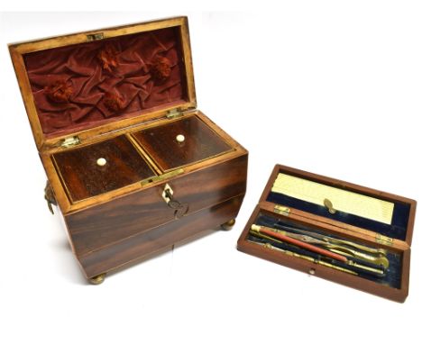 A MAHOGANY TWIN COMPARTMENT TEA CADDY  of sarcophagus form, with lion mask handles on brass ball feet, 20cm wide 12cm deep 17
