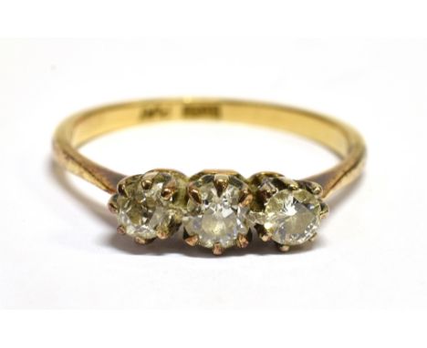 A DIAMOND THREE STONE 18 CARAT GOLD RING  the three round old cut diamonds weighing approx. 0.66 carat total, ring size P, gr