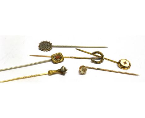 A COLLECTION OF SIX STICK PINS  comprising a diamond single stone set claw containing a rose cut diamond approx. 3mm x 3.5mm,