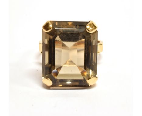 A LARGE SMOKY QUARTZ SINGLE STONE 9 CARAT GOLD DRESS RING the rectangular cut corner smoky quartz approx. 18mm x 15mm, four c