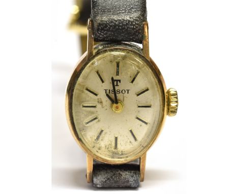 A LADIES 9 CARAT GOLD SMALL OVAL TISSOT WRISTWATCH on a leather strap, the watch 12mm x 20mm, watch head gross weight (includ