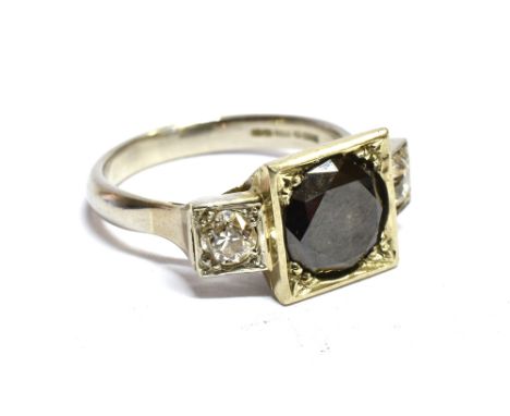 A BLACK AND WHITE DIAMOND, THREE STONE PLATINUM RING the round brilliant cut black diamond, weighing approx. 2 carats carre s