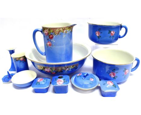 AN EXTENSIVE EDWARDIAN WASHBASIN SET  comprising jug, basin, two chamberpots, soap dish, candlestick etc., with floral decora